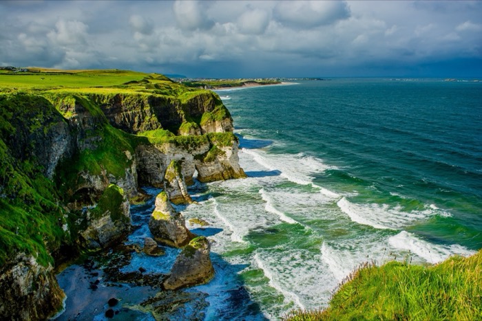 White limestone cliffs and green waves at Whiterocks Beach near Portrush