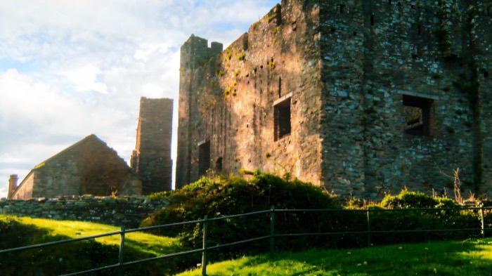 The stone keep of Greencastle Royal Castle in evening light