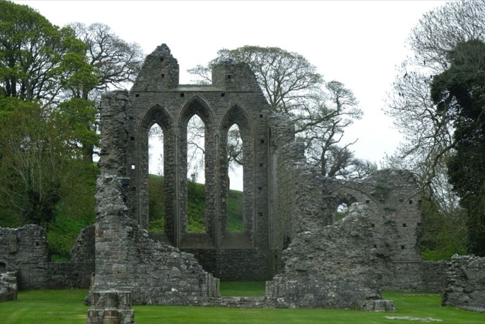 The tall Gothic arches of Inch Abbey standing on green lawns near Downpatrick