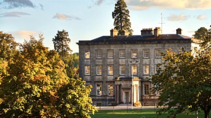 The grand stone Archbishop's Palace among autumn trees at the Palace Demesne in Armagh