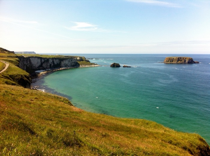 The turquoise bay and white cliffs at Larrybane Headland with Sheep Island offshore