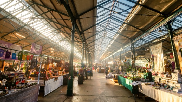Stalls under the iron and glass roof of St George's Market in Belfast