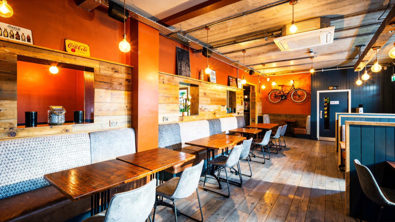 Rustic diner tables and booths where you grab a bite between games