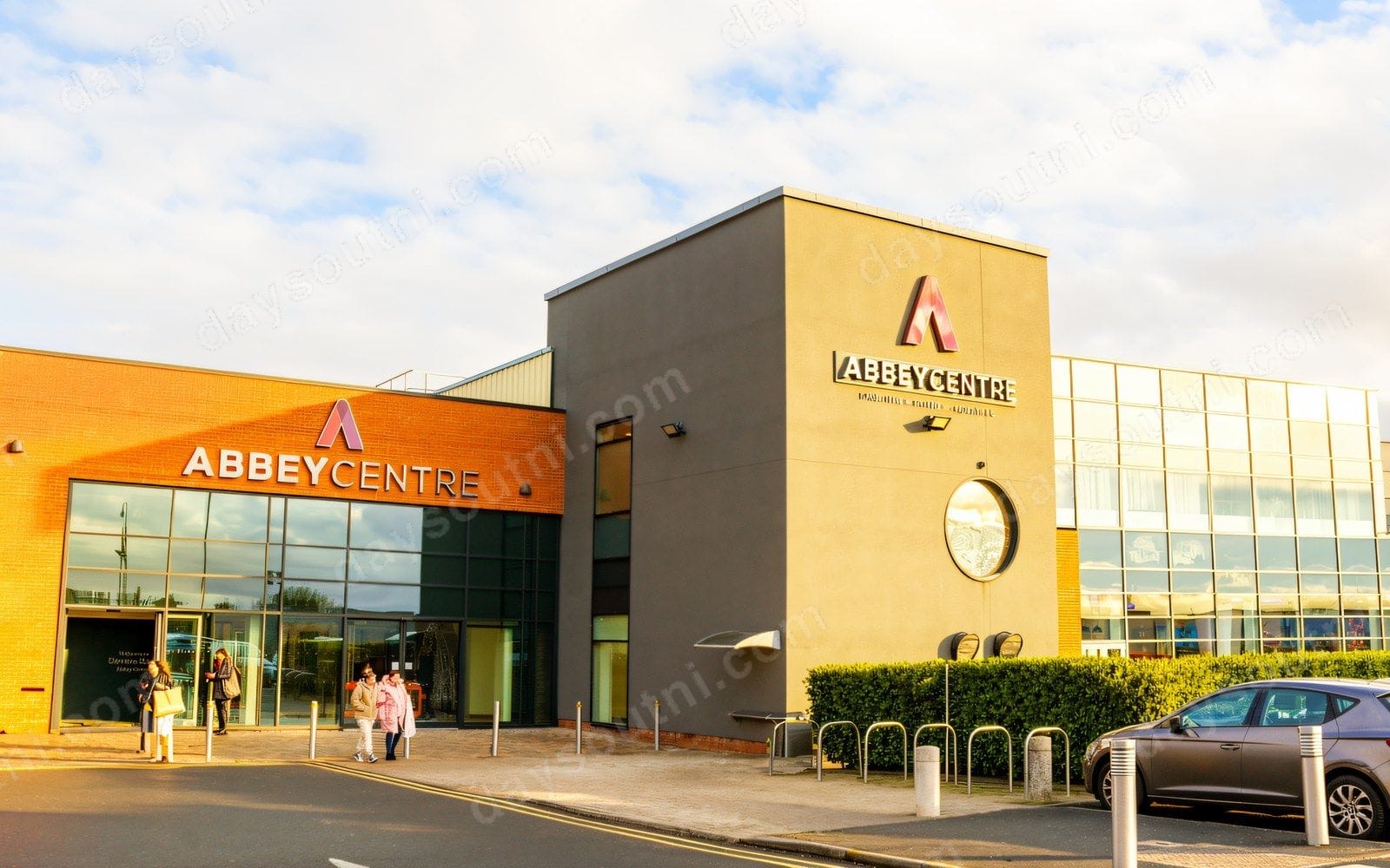 The main entrance of the Abbey Centre in Newtownabbey, with its red-brick and glass frontage and Abbey Centre sign