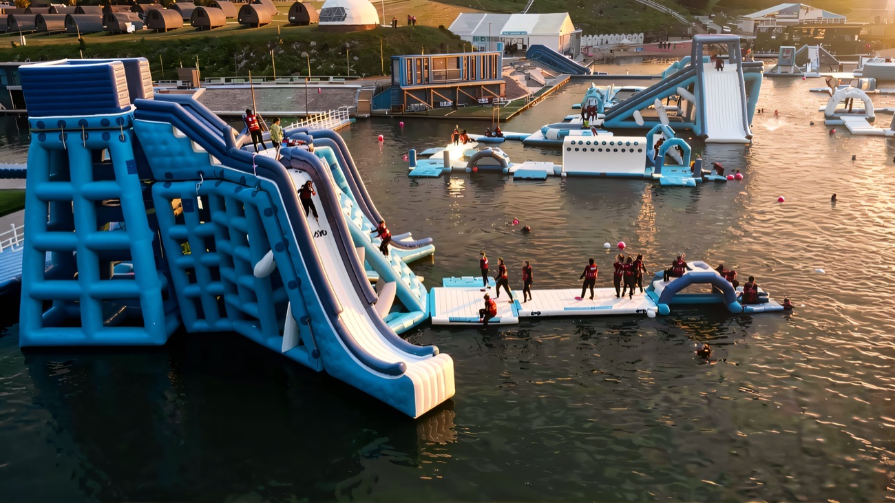The giant inflatable slide tower on the lake at Let's Go Hydro in evening light