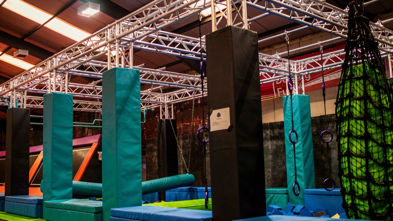 The ninja obstacle course with hanging rings and padded battle stations at Infinity Adventure Park