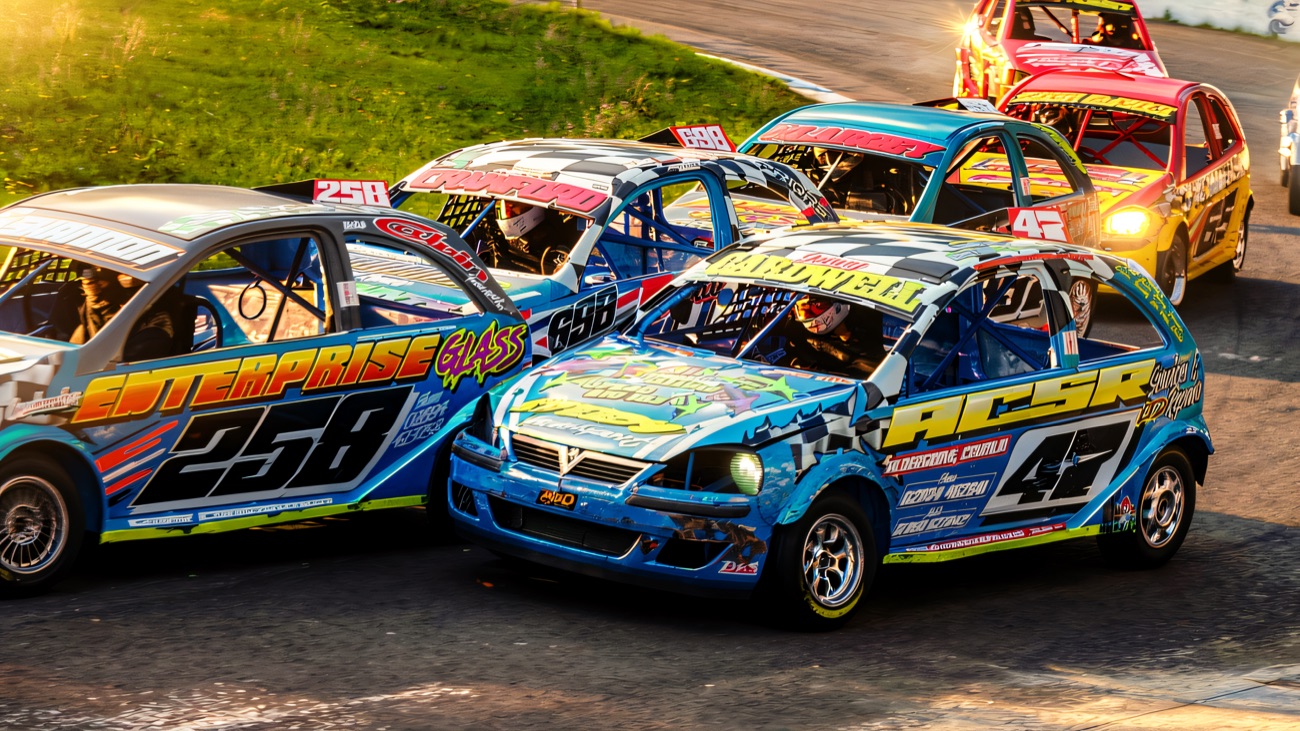 Colourful stock cars fighting for the lead on the Aghadowey oval