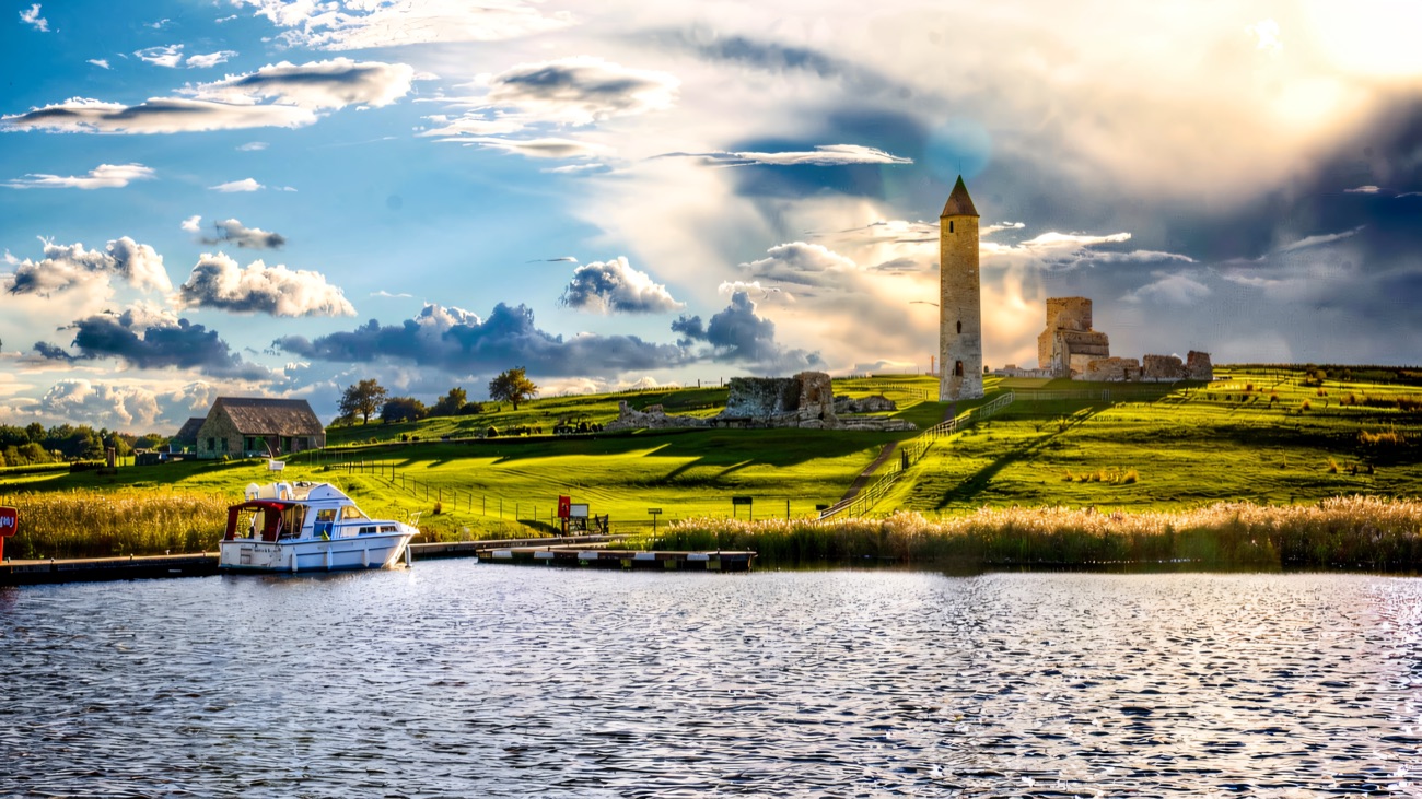 The Devenish Island round tower rising from the green shore, seen from the lough.