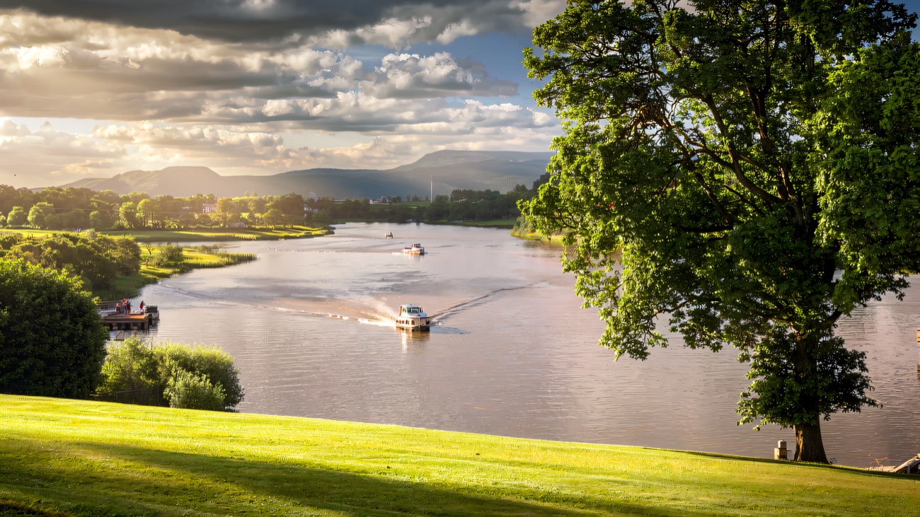 Boats cruising the wide Erne with the Fermanagh hills beyond.