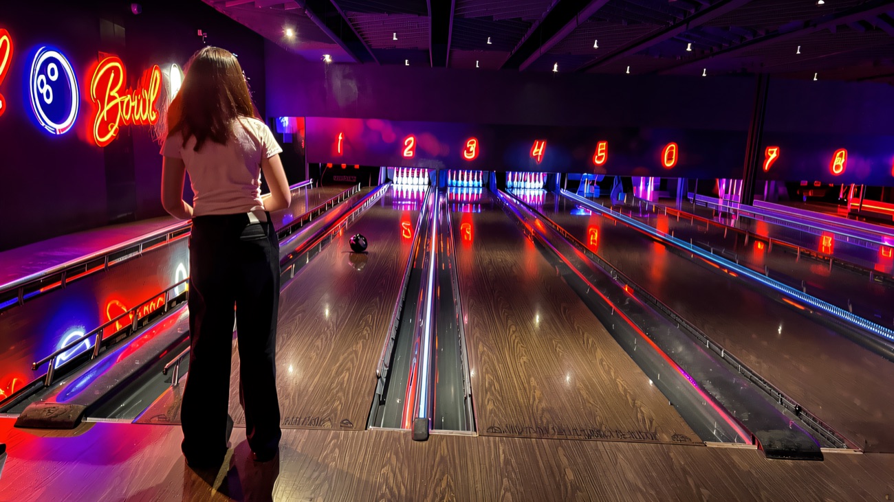 Neon-lit bowling lanes glowing pink and blue at Airtastic Bangor