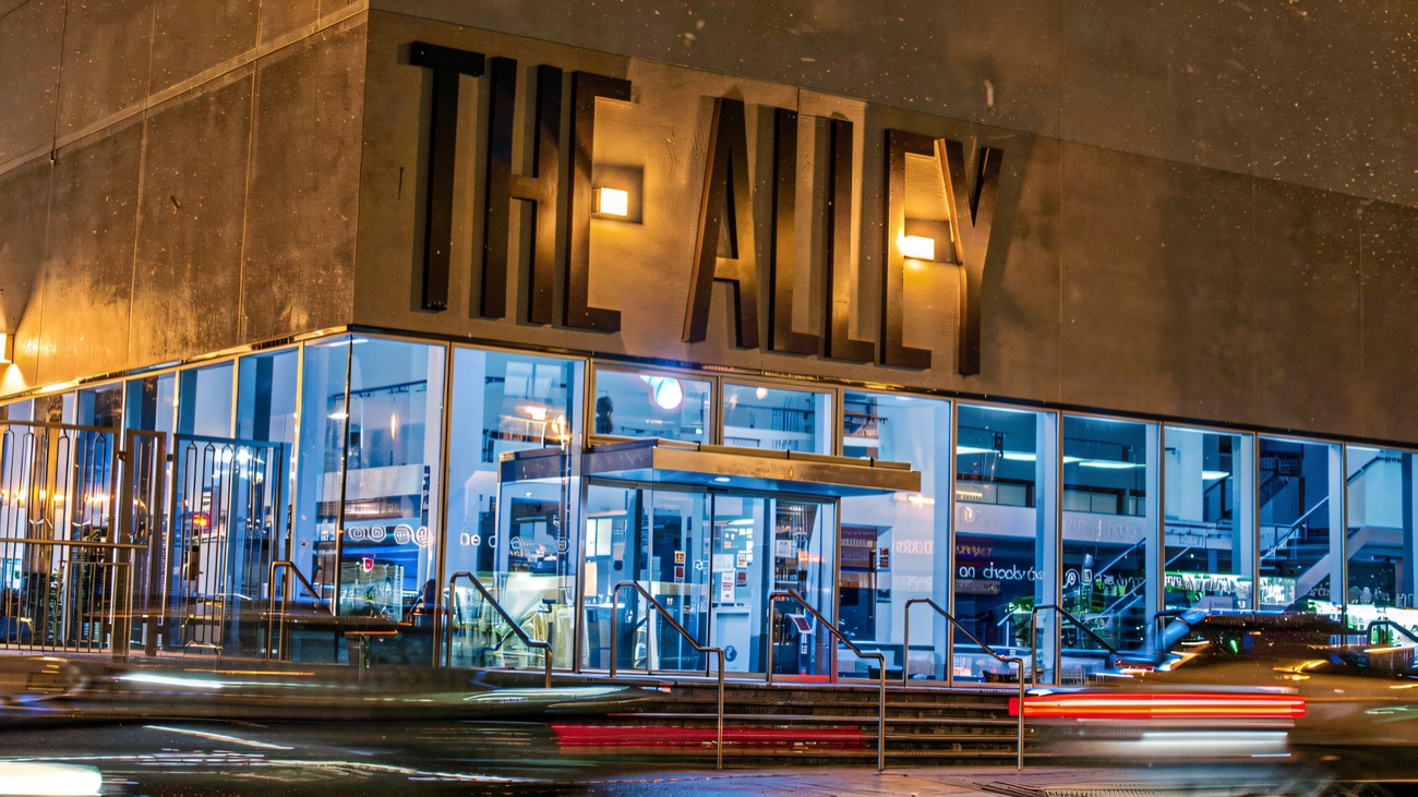 The bold blue-lit frontage of The Alley after dark