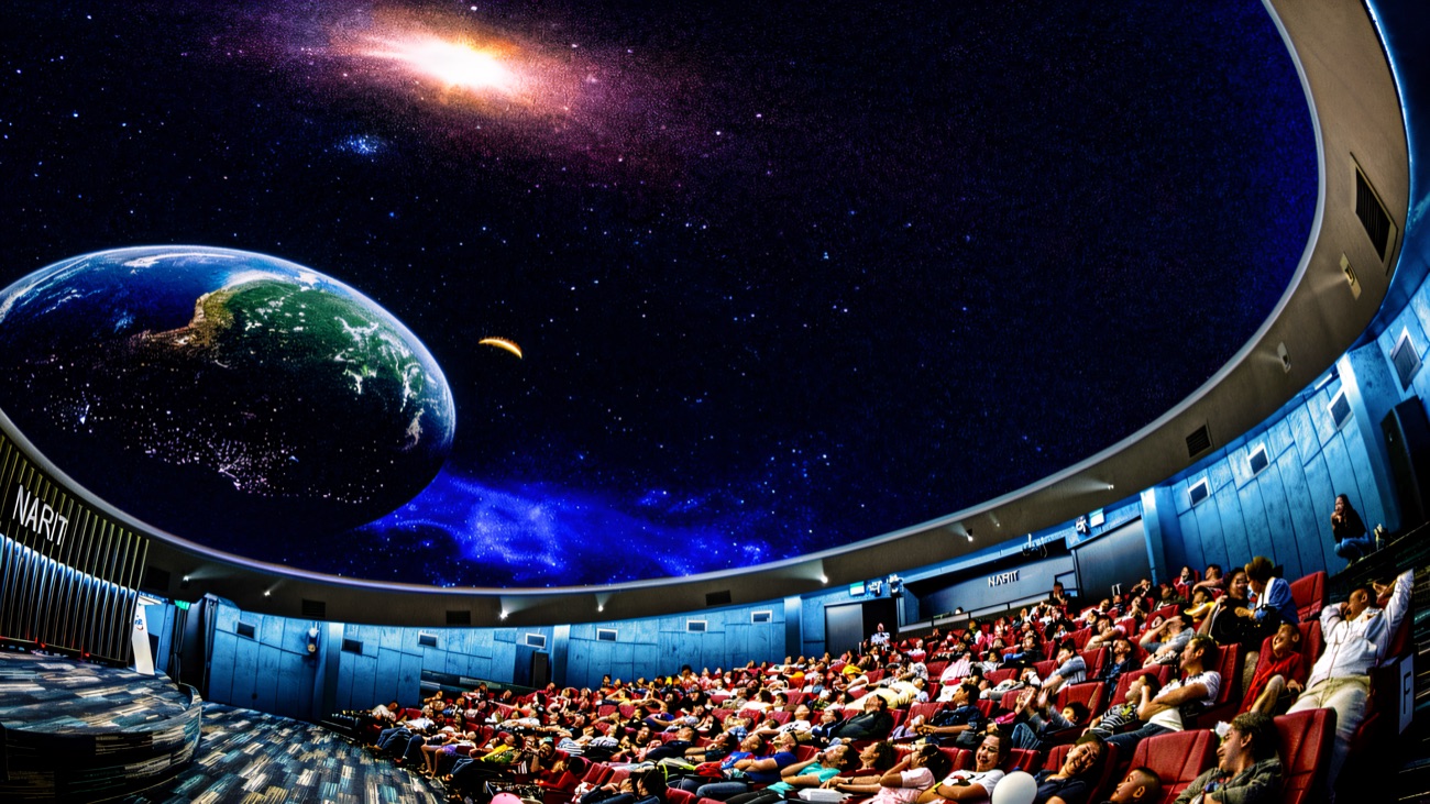 Inside the full-dome theatre, an audience reclined under a wraparound projection of Earth and the galaxy