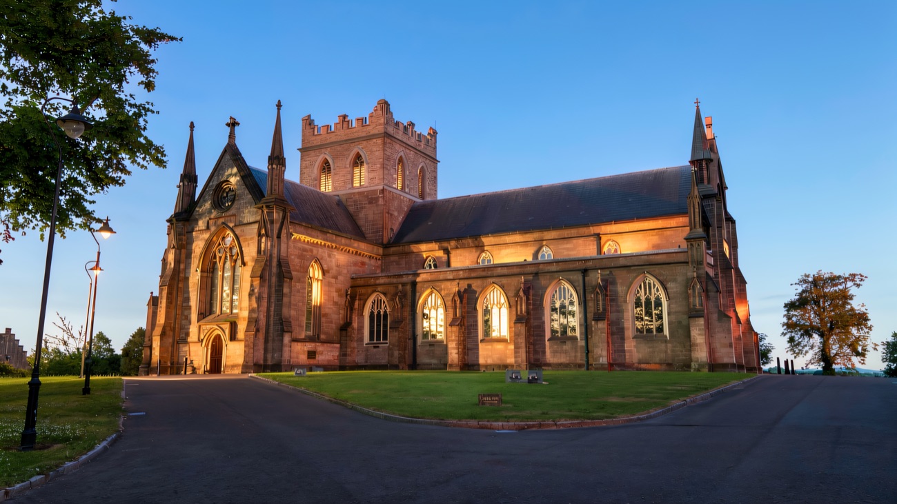 Warm evening light across the long sandstone flank and its rows of Gothic windows