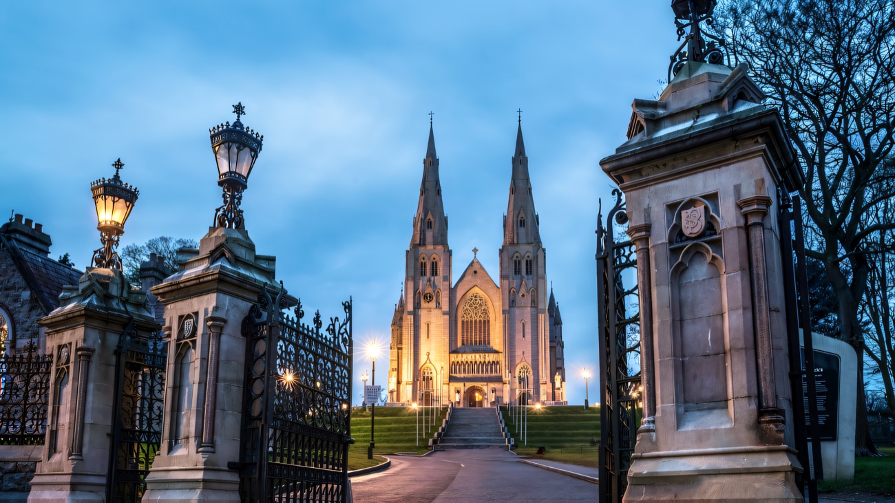 Looking up the tree-lined approach to the cathedral through the ornamental entrance gates.