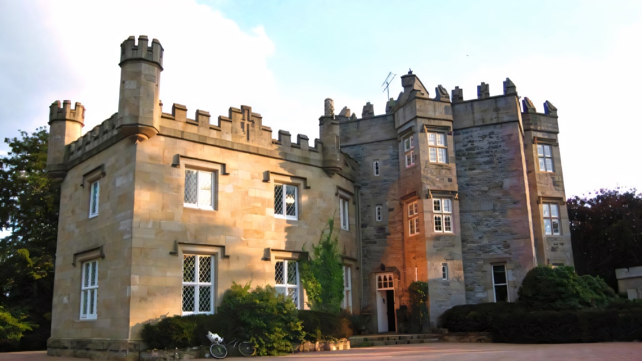 Augher Castle, the restored castellated stone house with its battlemented towers, seen from the forecourt