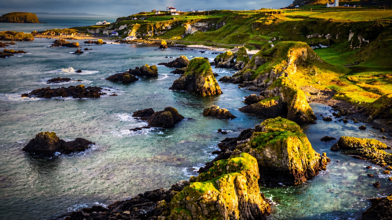 Sea stacks and green headlands along the Ballintoy shoreline from the air