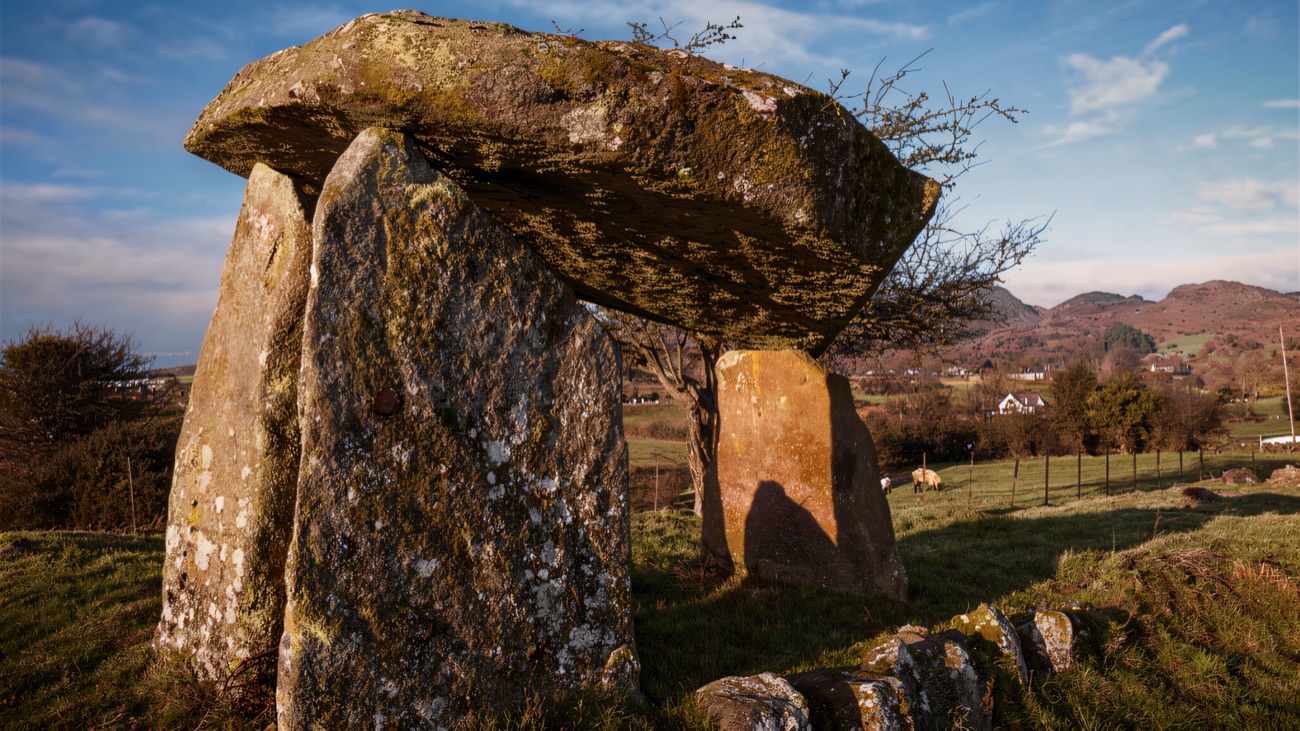 The great capstone poised on its portal stones, the Ring of Gullion rising behind
