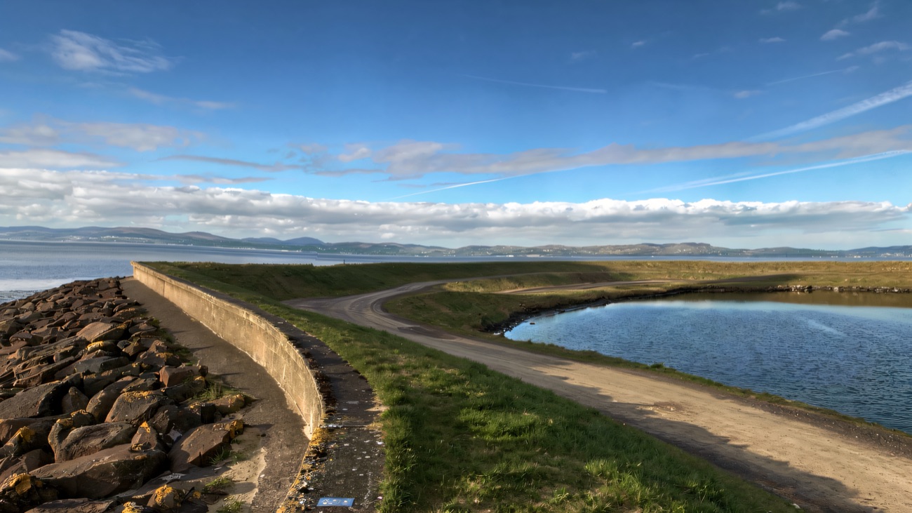 The embankment path curving along the shore toward the Inishowen hills