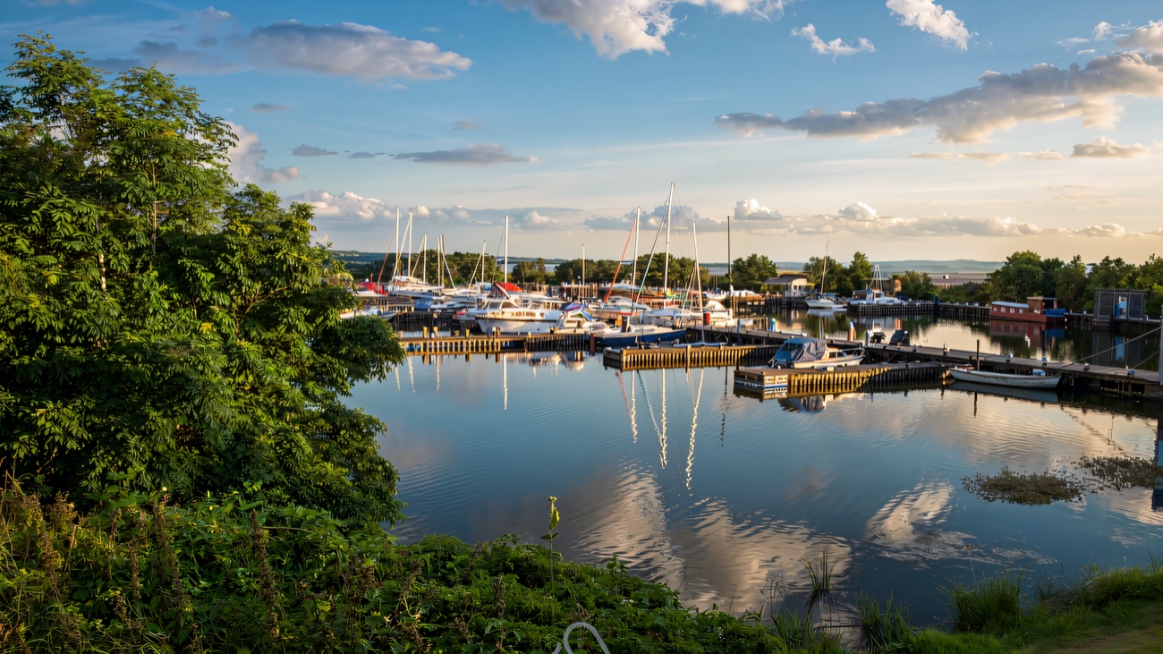 Yachts and cruisers resting at their moorings in the sheltered marina.