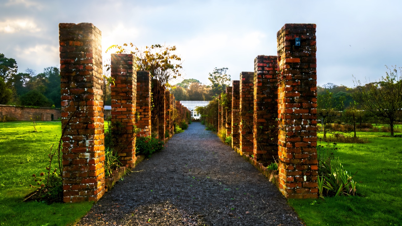 A gravel path running between tall brick pillars in the walled garden at Ballywalter Park