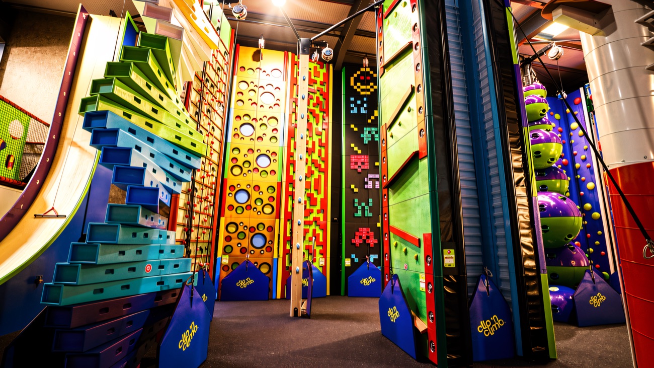 The indoor Clip 'n Climb hall with brightly coloured climbing challenges and auto-belay lines.