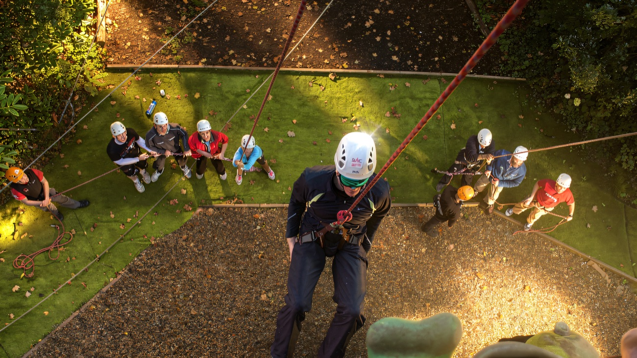 Abseiling the wall with the group belaying safely below