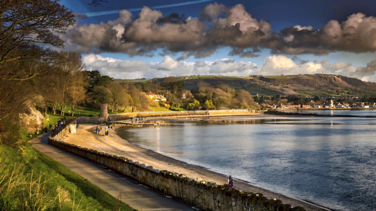 The path curves along the sea wall beside Belfast Lough