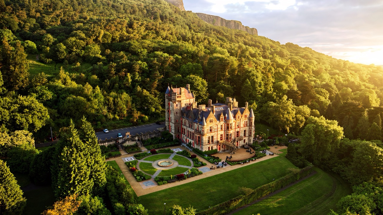 Aerial view of Belfast Castle and its terraced gardens on the wooded slopes of Cave Hill at sunset