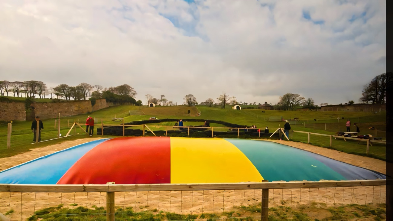The big colourful jumping pillow in the fenced play area at Mount Panther Farm Park