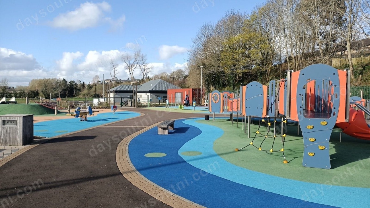 Blue and orange climbing units and rope ladders on bright rubber surfacing at Roe Mill Play Park in Limavady