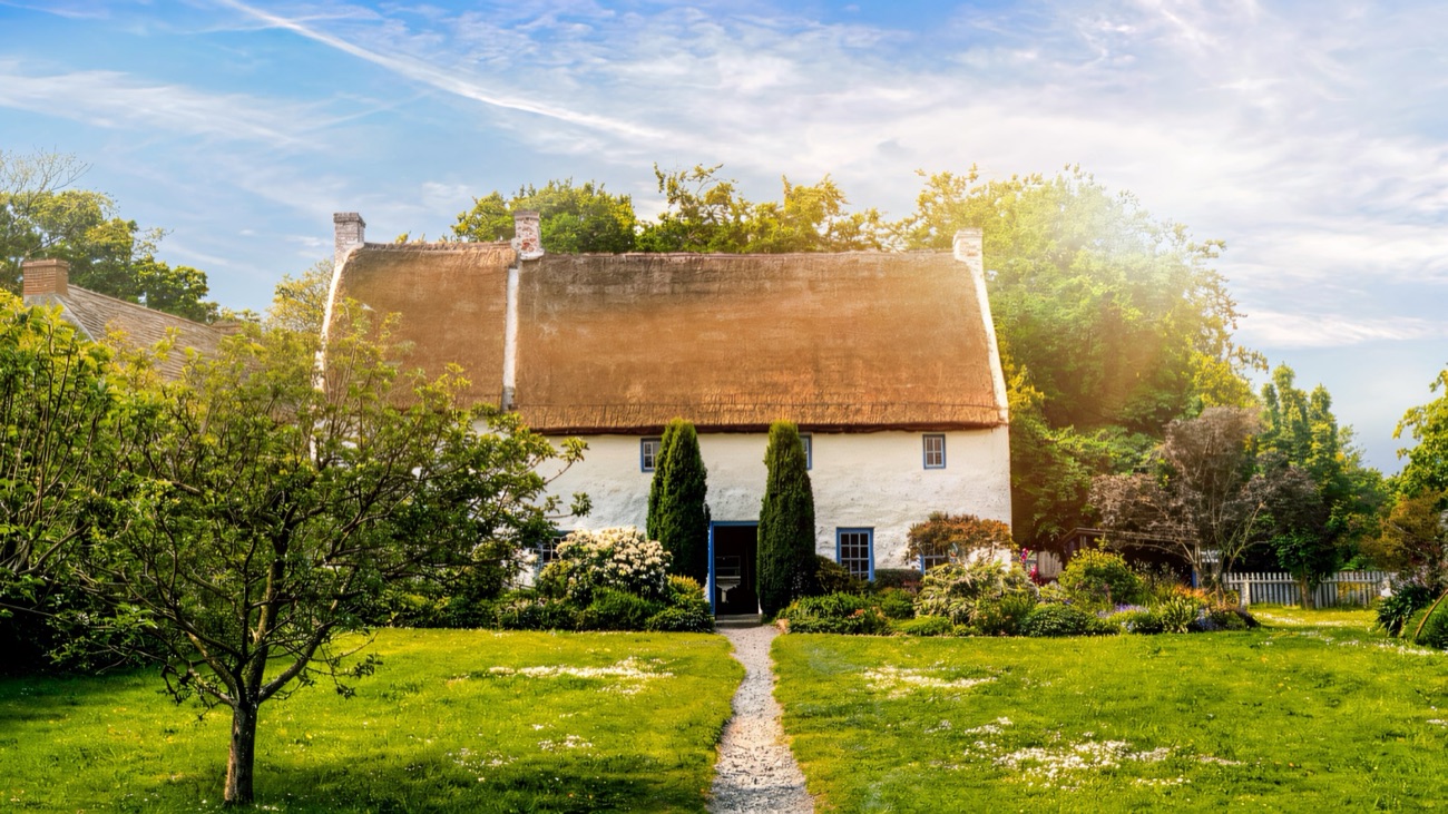 A whitewashed thatched cottage with a garden path at the Ulster Folk Museum, Cultra