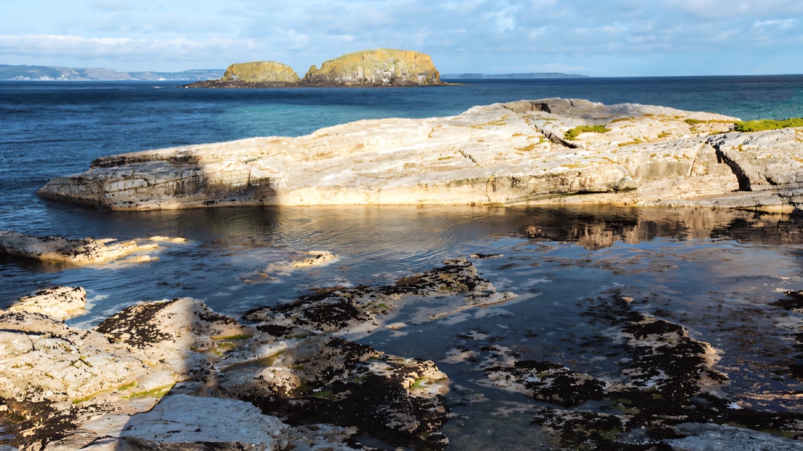 Rock pools on the limestone foreshore at Ballintoy at low tide