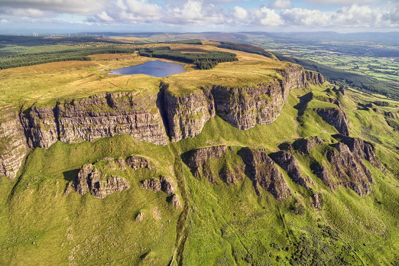 Binevenagh Lake sitting on the plateau at the top of the escarpment with the cliffs falling away beyond