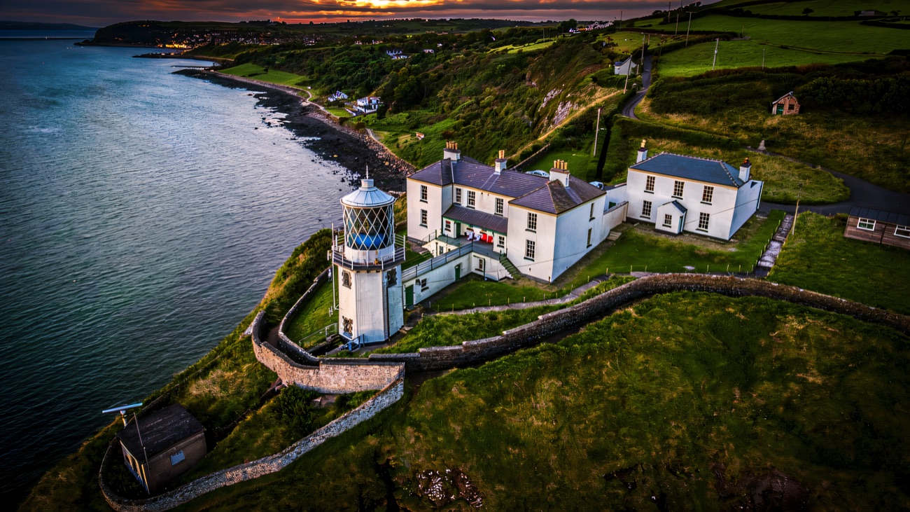 Aerial of Blackhead Lighthouse and keepers' cottages above Whitehead