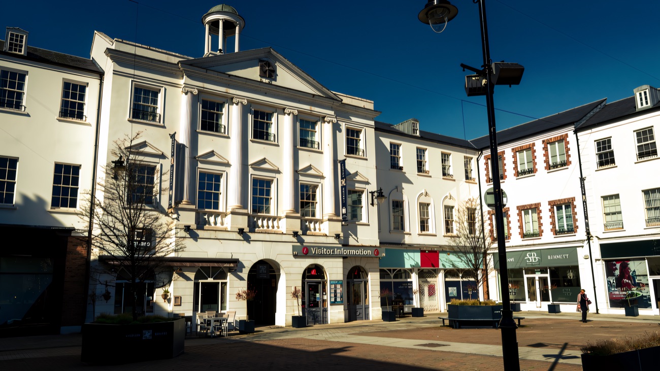 The white Visitor Information Centre building on Lisburn Square, near Bow Street Mall