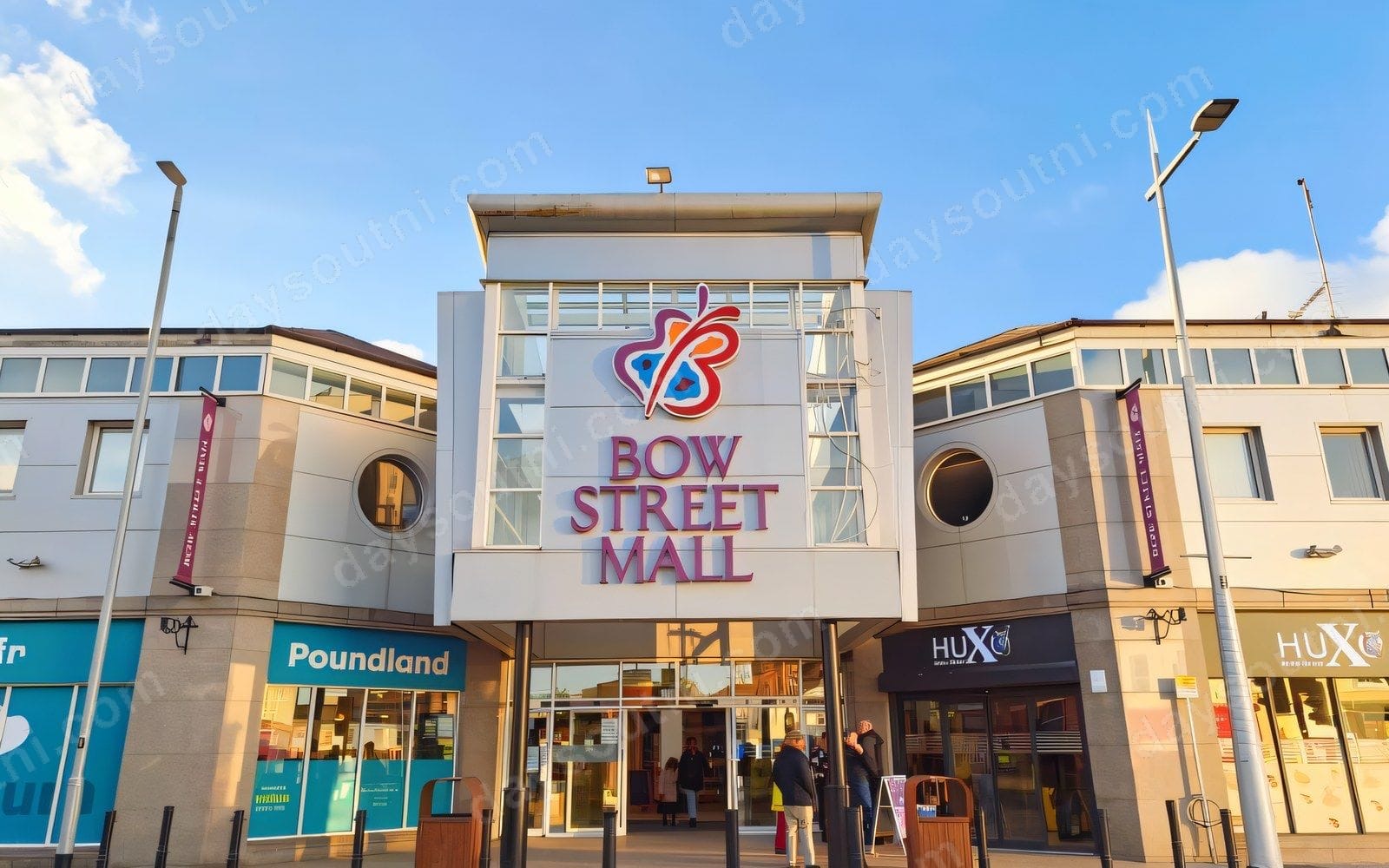 The front entrance of Bow Street Mall in Lisburn, with the centre's butterfly sign above the doors on the pedestrianised street