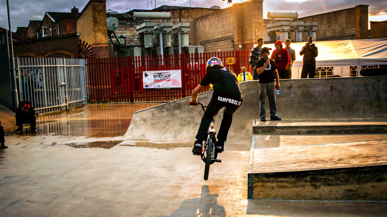 Rider dropping in past the Bridges Urban Sports Park banner