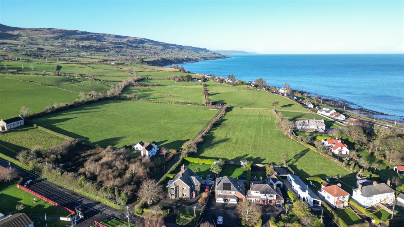 Rolling patchwork fields and farmland above Cairncastle running down to the blue Antrim sea