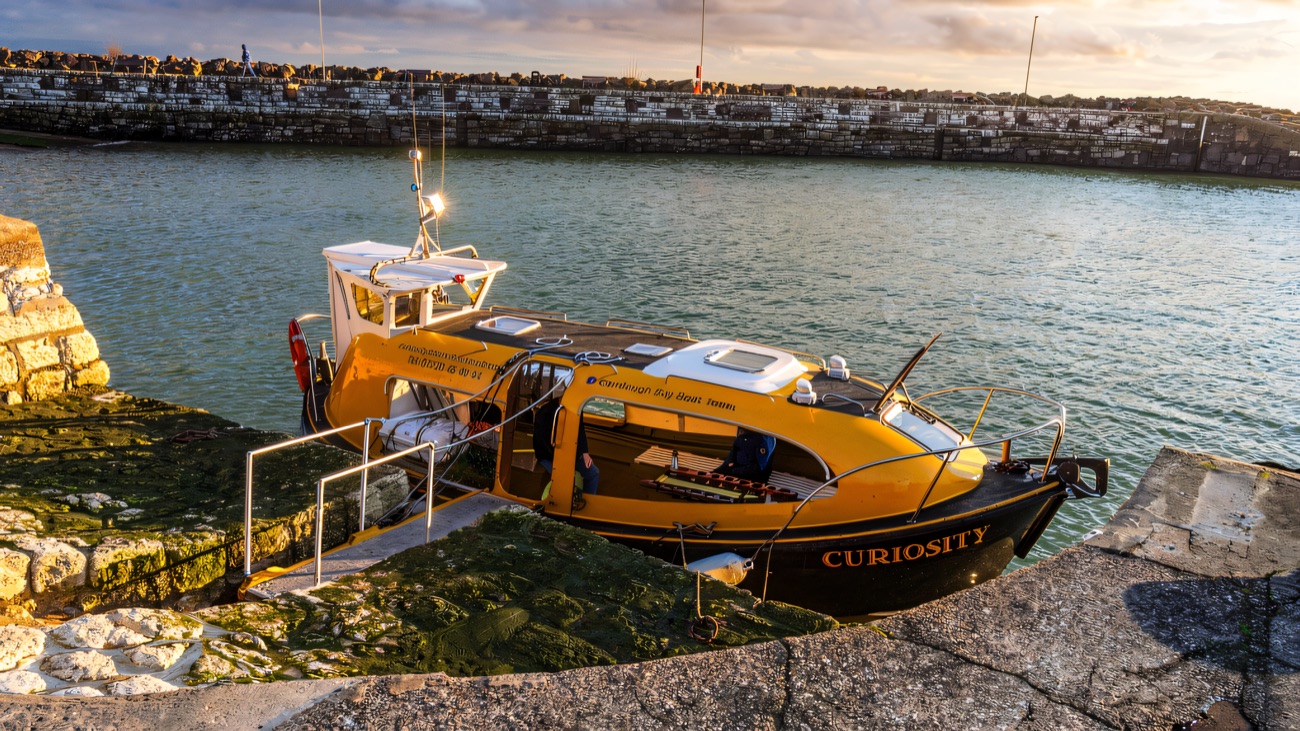 The boat Curiosity tied up ready at the harbour steps