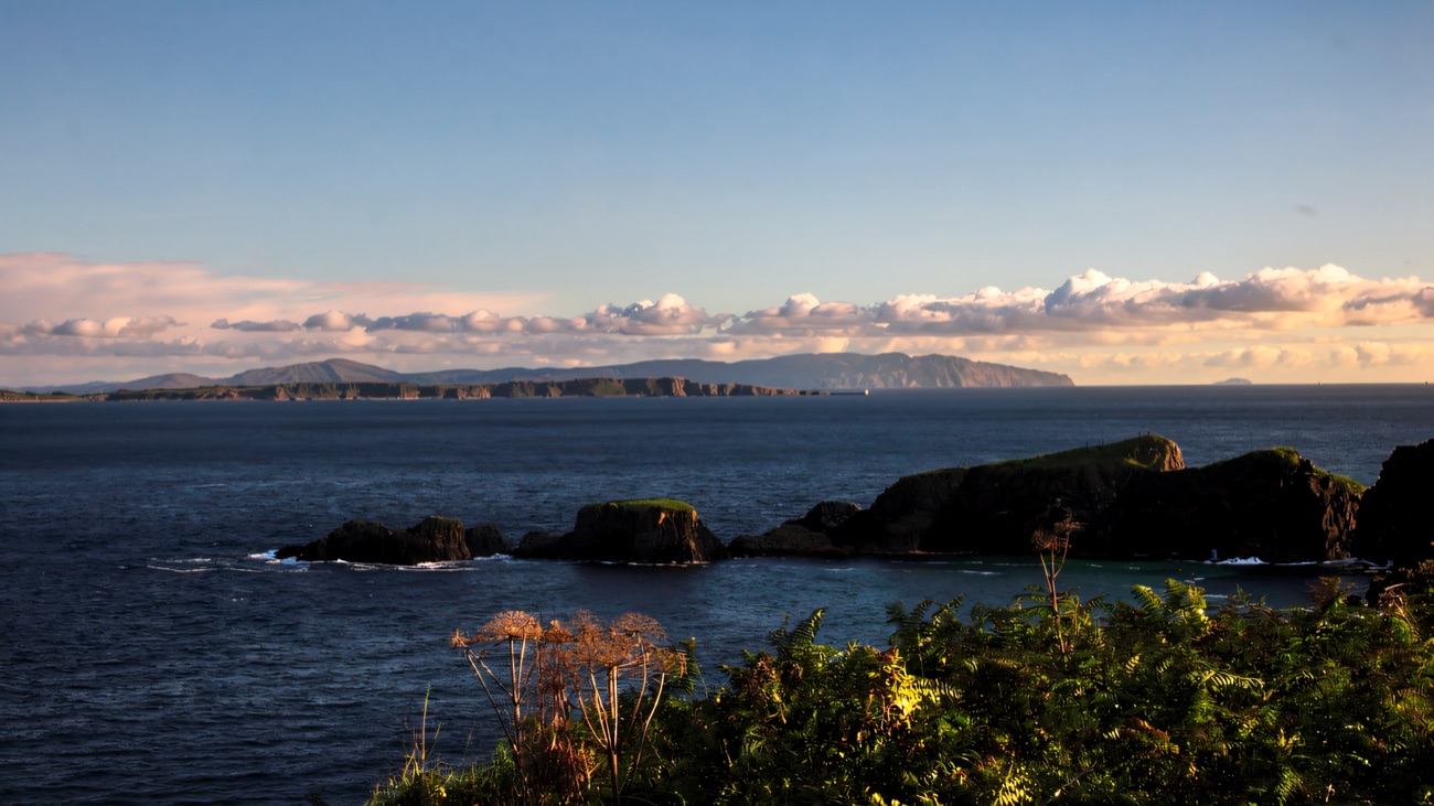 Wide sea view from the clifftop out to Rathlin Island across the blue water