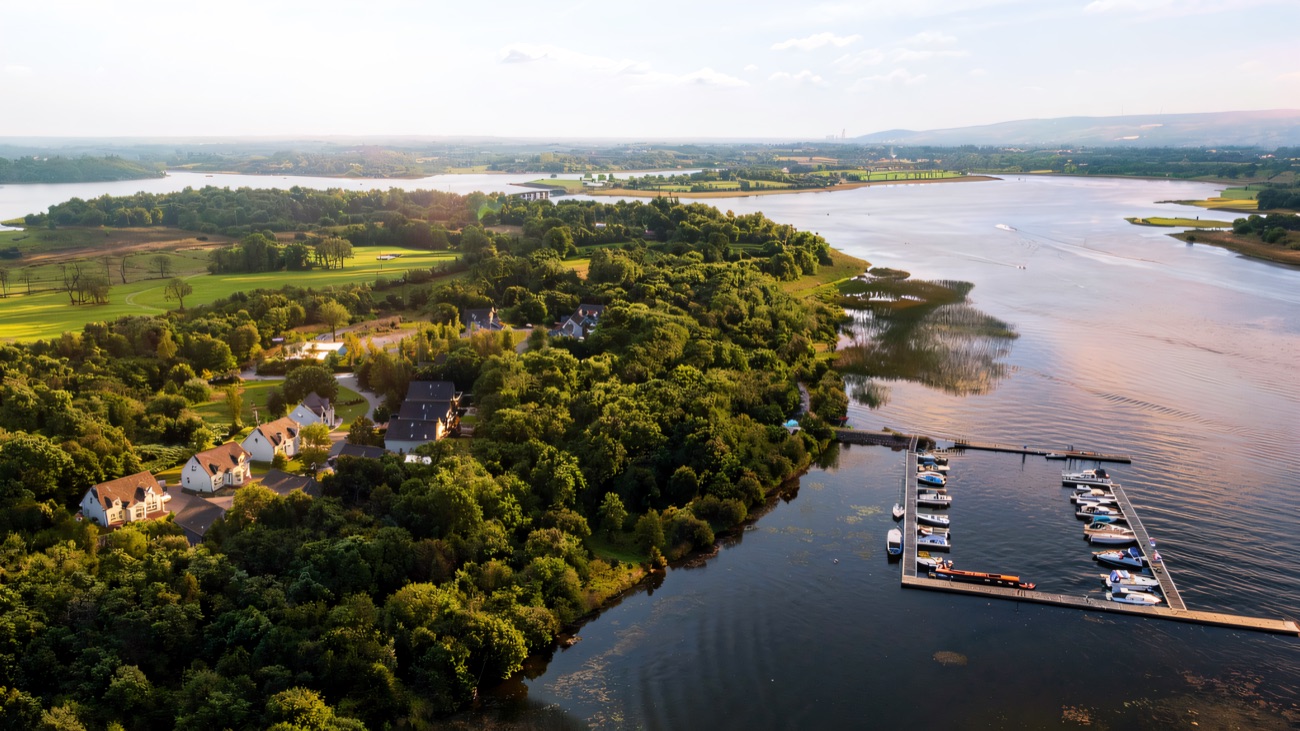 A lakeside marina with cruisers lined up along the pontoons.