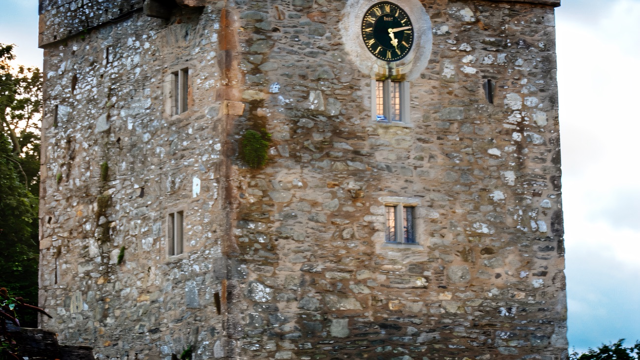 The tall battlemented tower house and clock tower at Castle Ward's farmyard, close up