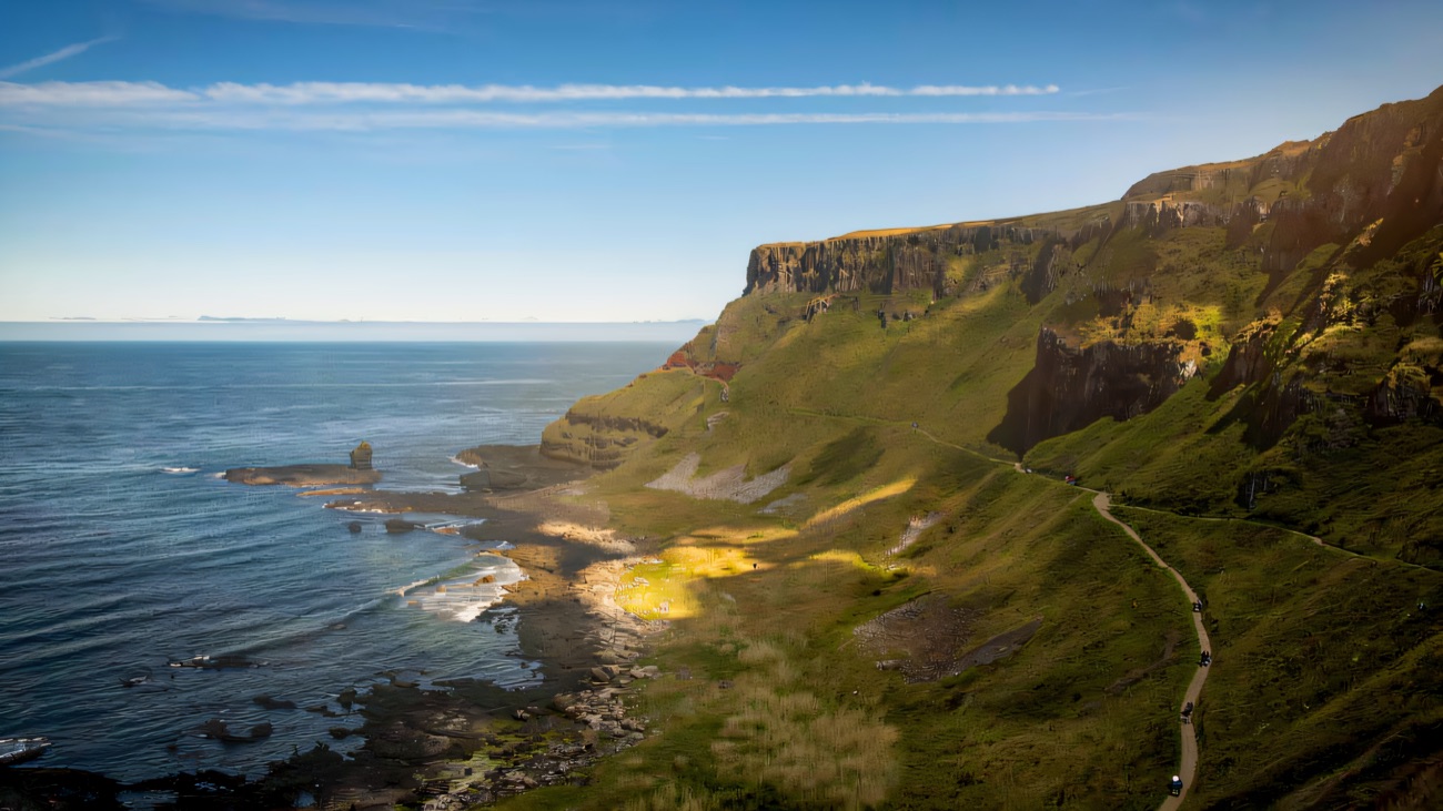 The clifftop path threading along the green headland above the ocean