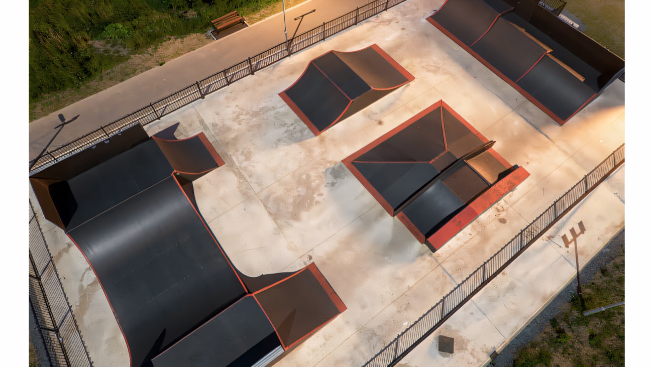 The whole skate park from above, ramps and banks laid out inside the fence