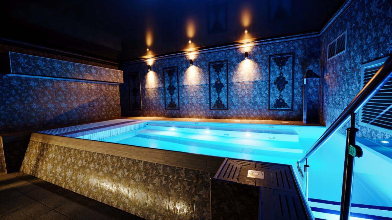 The hydrotherapy pool lit deep blue, jets bubbling along the far wall.