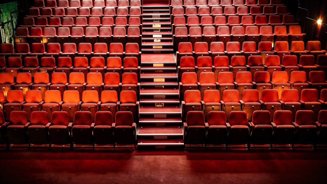 The Craic Theatre's raked red-seat auditorium