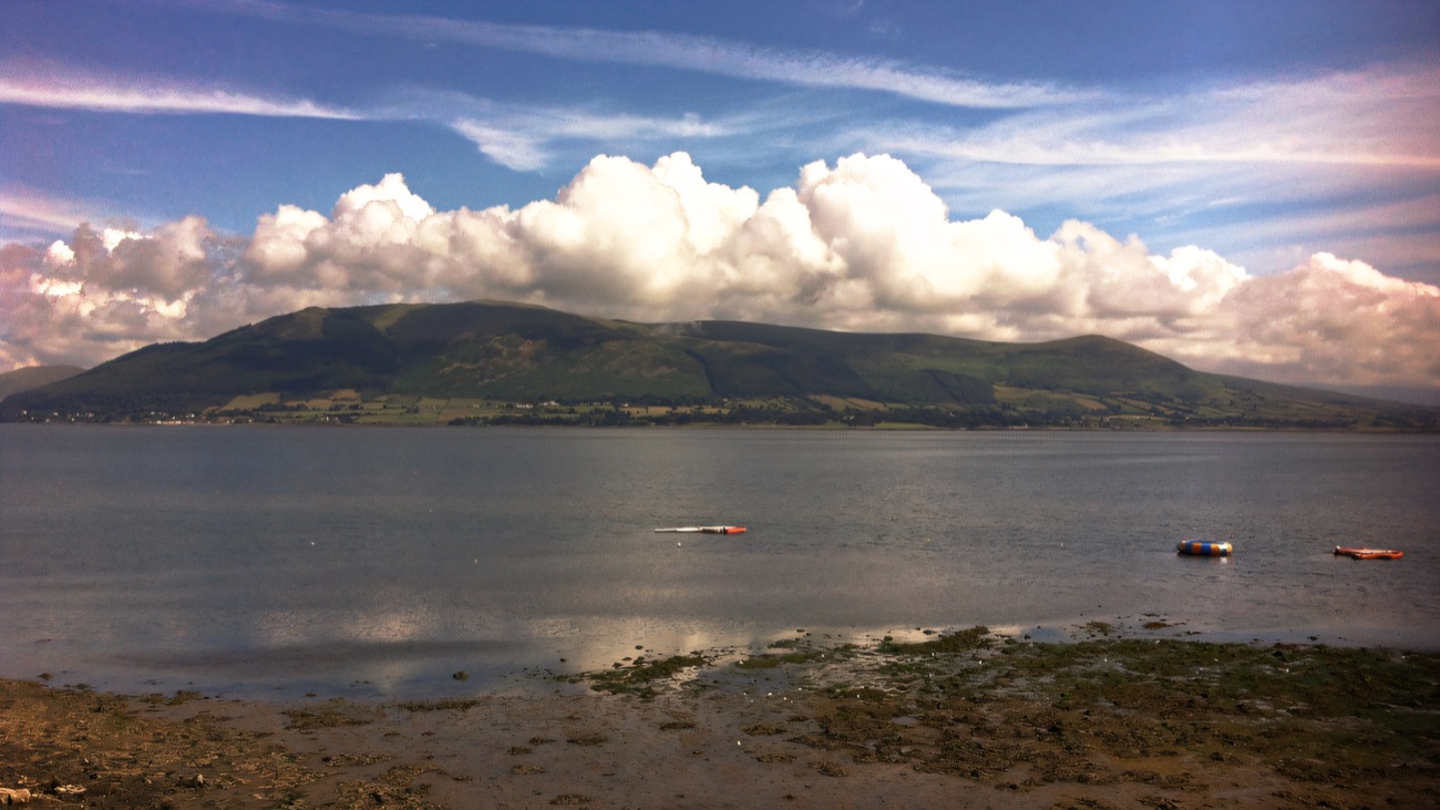 The view across Carlingford Lough to the hills from the Cranfield shore under a big cloudy sky