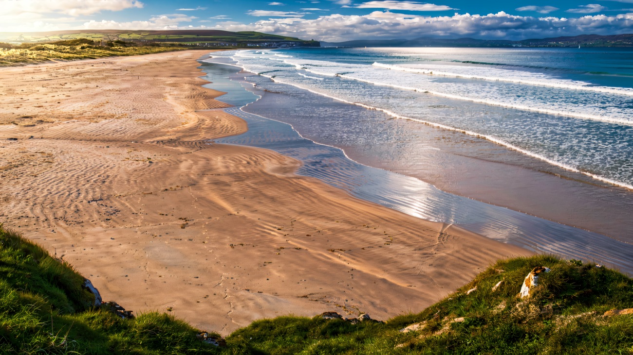 The wide golden sweep of Portstewart Strand nearby, the sea coming in against green dunes