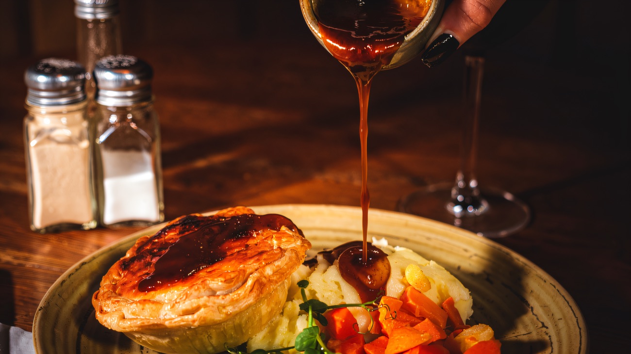 A pie supper with mash, peas and carrots served in the bar