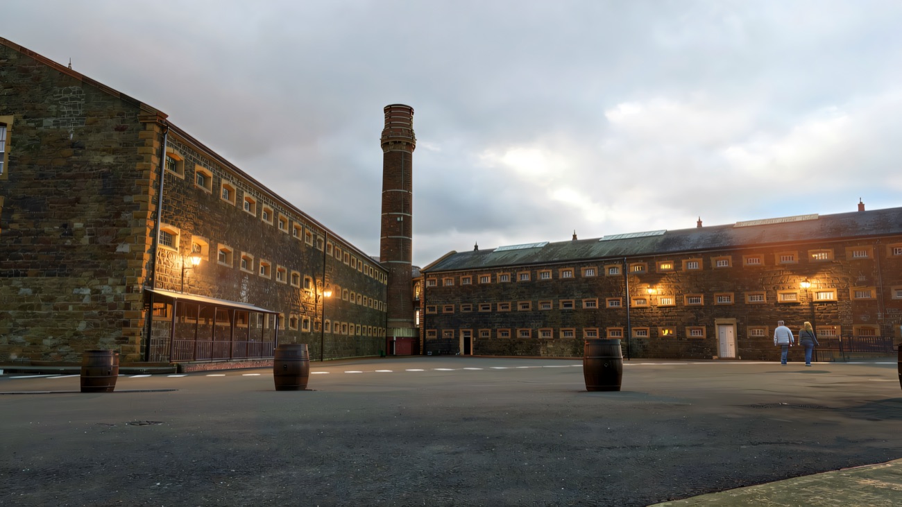 The bleak exercise yard between the cell blocks, the brick chimney of the old boiler house standing over it.